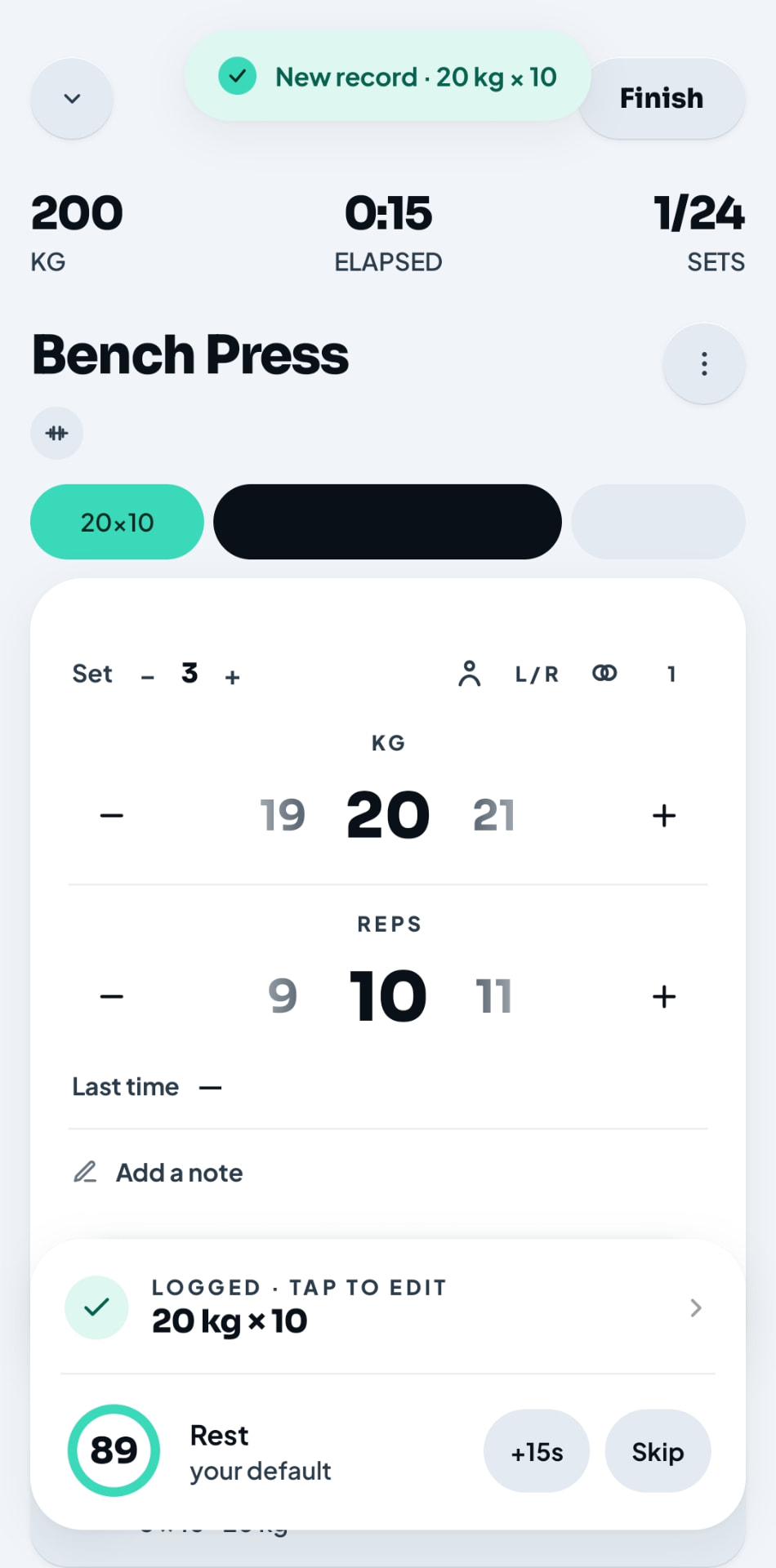 Chalk light mode logged set screen showing a new record and rest timer
