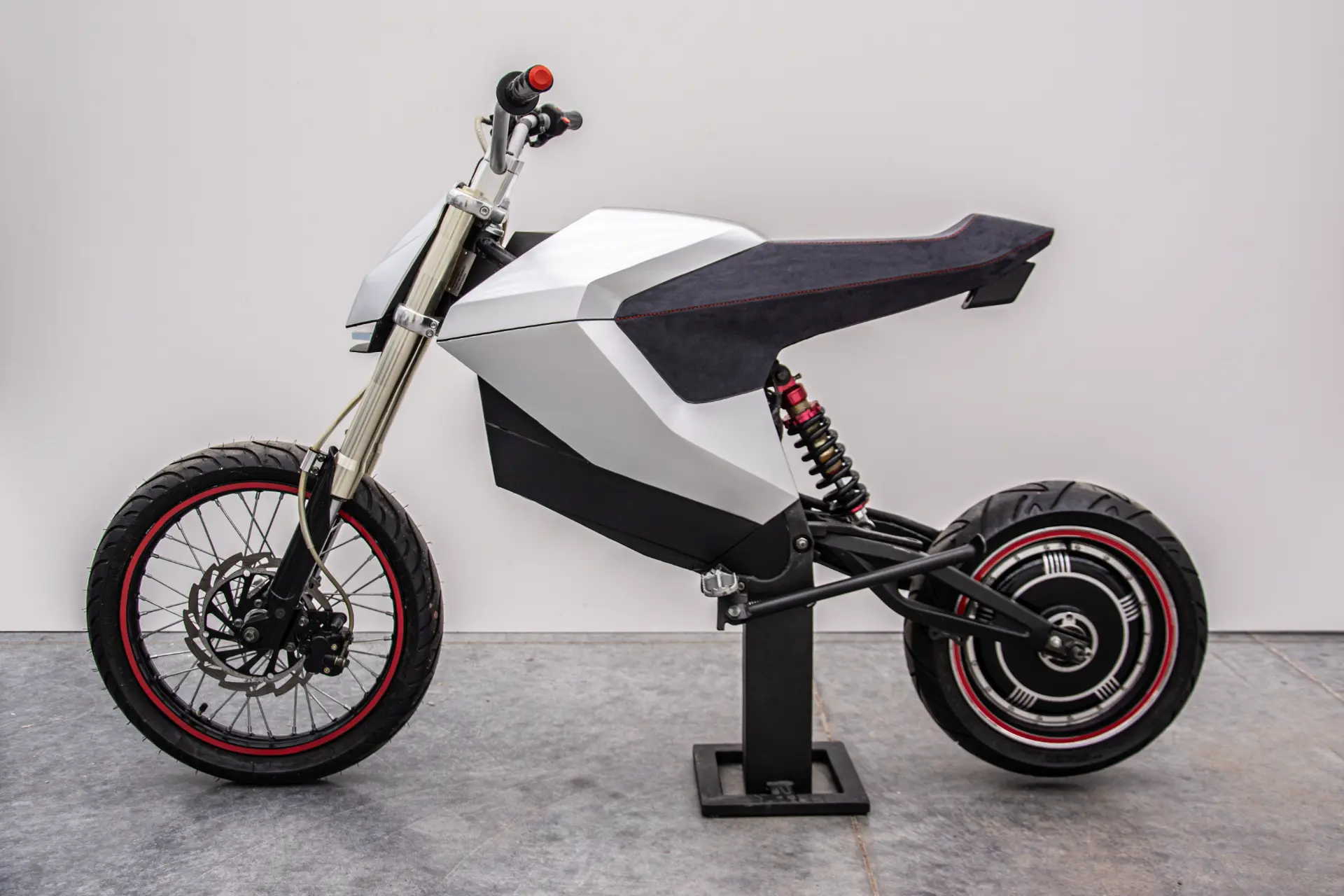 Full side profile of the E-moto prototype on a stand